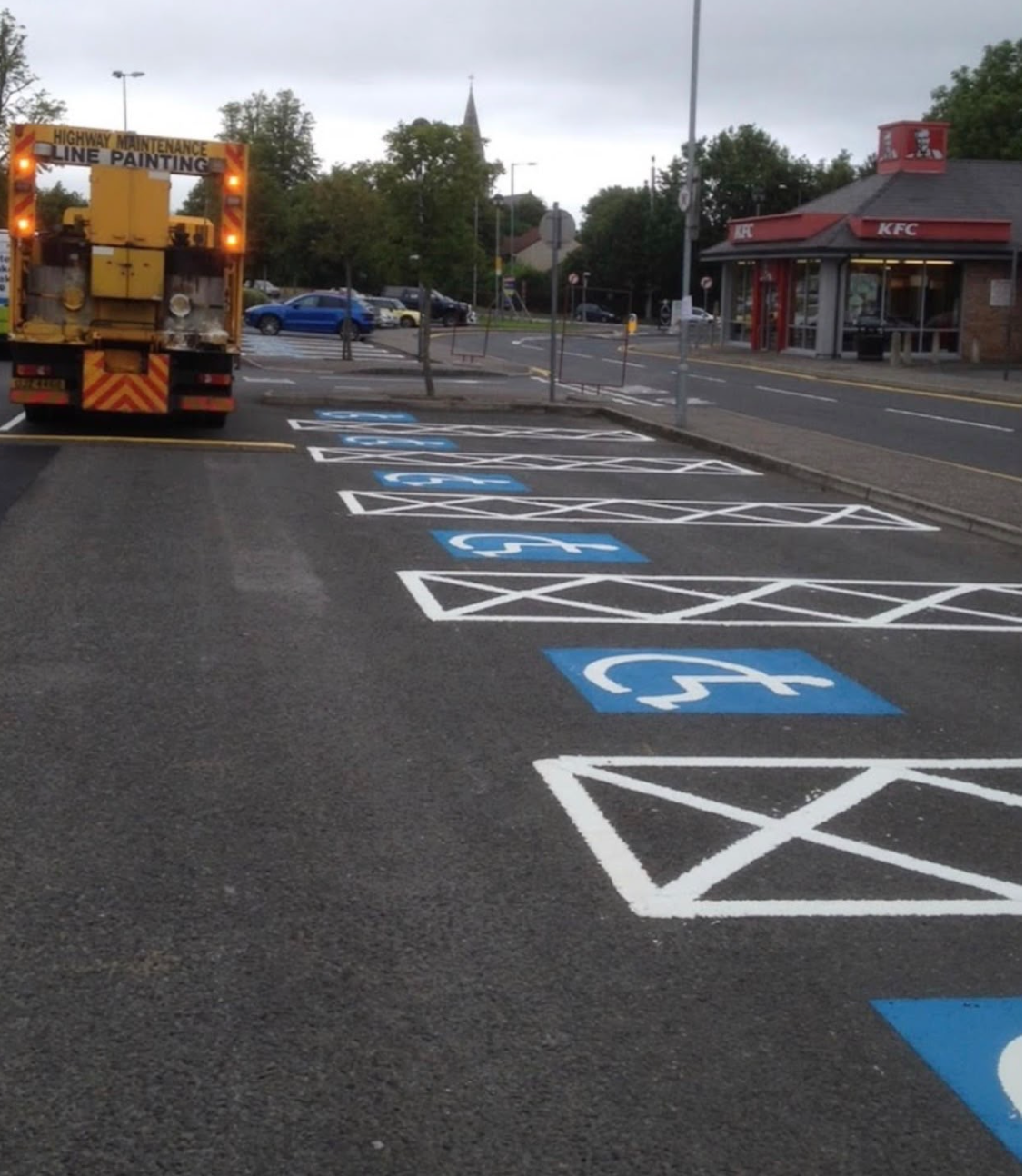 Mid Ulster Line Marking crew painting disabled parking bays